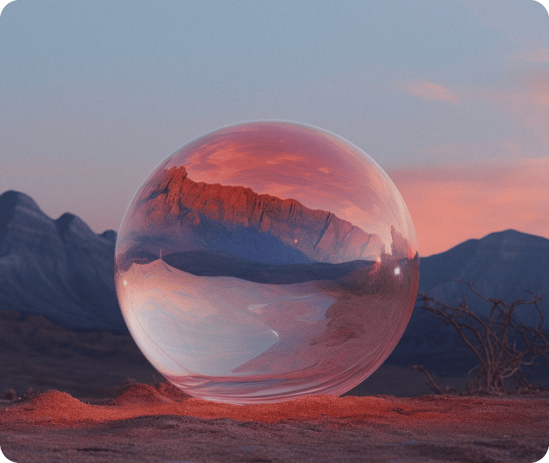 A clear sphere reflects a red mountain landscape at sunset in a desert setting.