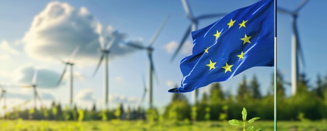ESMA 1 European Union flag with wind turbines in the background, symbolizing sustainability and renewable energy.